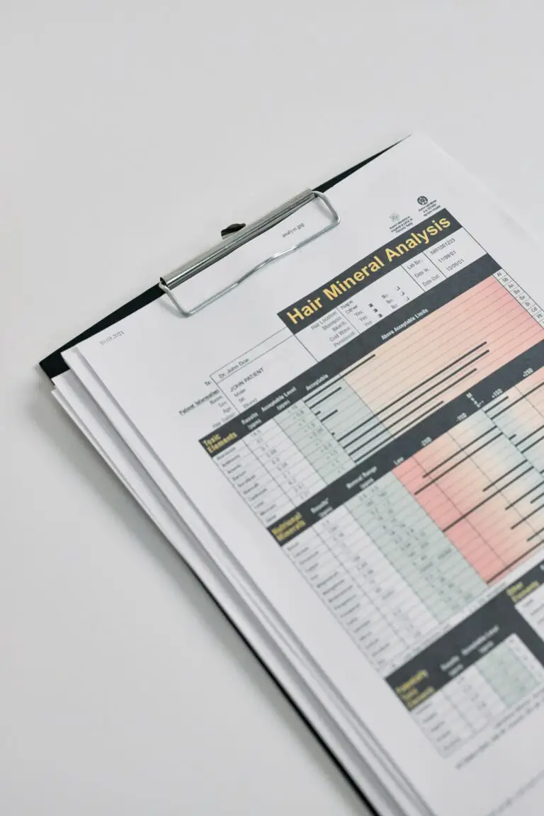 Close-up of a printed hair mineral analysis report on a clipboard, emphasizing health diagnostics.